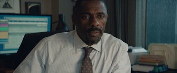 Movie still from “Molly's Game” (2017), directed by Aaron Sorkin – A man in a white dress shirt and a brown tie; Close Up shot, Over the shoulder angle