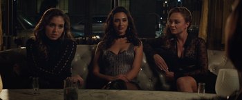 Movie still from “Molly's Game” (2017), directed by Aaron Sorkin – A woman sitting on a couch in front of two other women; Medium shot, High angle