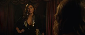 Movie still from “Molly's Game” (2017), directed by Aaron Sorkin – A woman standing in front of a mirror in front of a curtain; Medium shot, Over the shoulder angle