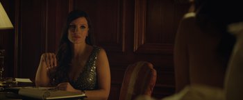 Movie still from “Molly's Game” (2017), directed by Aaron Sorkin – A woman sitting at a table in front of a book; Close Up shot, Over the shoulder angle