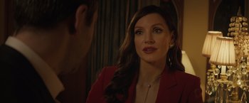 Movie still from “Molly's Game” (2017), directed by Aaron Sorkin – A woman in a red jacket looking at a man in a red suit; Close Up shot, Over the shoulder angle
