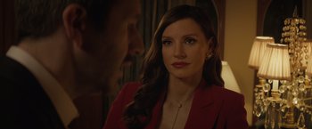 Movie still from “Molly's Game” (2017), directed by Aaron Sorkin – A woman in a red jacket looking at a man in a red suit; Close Up shot, Over the shoulder angle