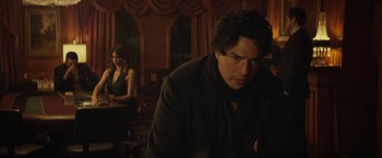 Movie still from “Molly's Game” (2017), directed by Aaron Sorkin – A man and a woman in a dark room; Medium shot, Over the shoulder angle