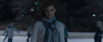 Movie still from “Molly's Game” (2017), directed by Aaron Sorkin – A woman wearing a white sweater and a scarf; Medium shot, Low angle