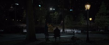 Movie still from “Molly's Game” (2017), directed by Aaron Sorkin – Two people are sitting on a park bench at night; Extreme Wide shot, High angle