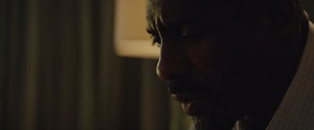 Movie still from “Molly's Game” (2017), directed by Aaron Sorkin – A man's face in the dark; Close Up shot, Low angle