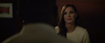 Movie still from “Molly's Game” (2017), directed by Aaron Sorkin – A woman with long brown hair is looking at the camera; Close Up shot, Over the shoulder angle