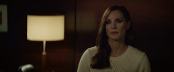 Movie still from “Molly's Game” (2017), directed by Aaron Sorkin – A woman in a white sweater looking at the camera; Close Up shot, Over the shoulder angle