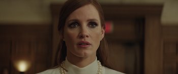 Movie still from “Molly's Game” (2017), directed by Aaron Sorkin – A person wearing a white shirt and pearls; Close Up shot, Low angle