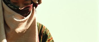 Movie still from “Mongol: The Rise of Genghis Khan” (2007), directed by Sergei Bodrov – A person wearing a neck tie and a colorful shirt; Extreme Close Up shot, Low angle