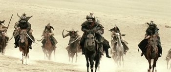 Movie still from “Mongol: The Rise of Genghis Khan” (2007), directed by Sergei Bodrov – A group of men riding on the backs of horses; Wide shot, High angle