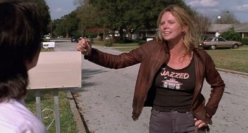 Movie still from “Monster” (2003), directed by Patty Jenkins – A woman standing next to a mailbox on the side of a road; Medium shot, Low angle