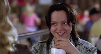 Movie still from “Monster” (2003), directed by Patty Jenkins – A person holding a cup of coffee; Close Up shot, Over the shoulder angle