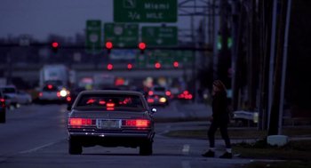 Movie still from “Monster” (2003), directed by Patty Jenkins – A woman crossing the street at a busy intersection; Wide shot, Over the shoulder angle