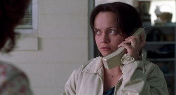 Movie still from “Monster” (2003), directed by Patty Jenkins – A woman talking on a phone while sitting down; Close Up shot, High angle