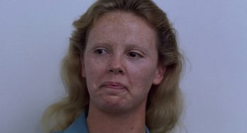 Movie still from “Monster” (2003), directed by Patty Jenkins – A person wearing a blue shirt; Close Up shot, Low angle