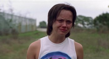 Movie still from “Monster” (2003), directed by Patty Jenkins – A woman in a white shirt is crying outside; Close Up shot, Over the shoulder angle