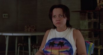 Movie still from “Monster” (2003), directed by Patty Jenkins – A woman in a white shirt with palm trees on it; Close Up shot, Low angle