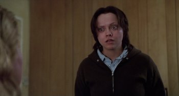 Movie still from “Monster” (2003), directed by Patty Jenkins – A person with a black jacket and blue glasses; Close Up shot, Low angle