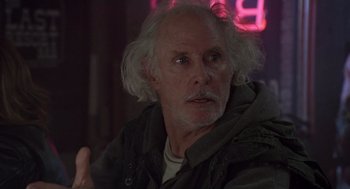 Movie still from “Monster” (2003), directed by Patty Jenkins – An older man with white hair is looking at the camera; Close Up shot, Over the shoulder angle