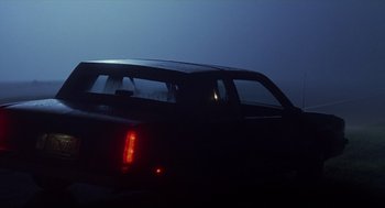Movie still from “Monster” (2003), directed by Patty Jenkins – A car that is sitting in the dark outside; Wide shot, Low angle