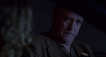 Movie still from “Monster” (2003), directed by Patty Jenkins – A person wearing a jacket and a hat; Close Up shot, Over the shoulder angle