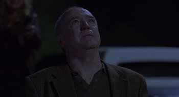 Movie still from “Monster” (2003), directed by Patty Jenkins – A man in a brown jacket looking up at the sky; Close Up shot, Low angle