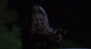 Movie still from “Monster” (2003), directed by Patty Jenkins – A woman is holding a gun in her hands; Close Up shot, Low angle