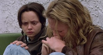 Movie still from “Monster” (2003), directed by Patty Jenkins – Two women sitting next to each other with their heads down; Close Up shot, Low angle