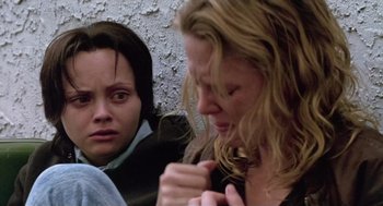 Movie still from “Monster” (2003), directed by Patty Jenkins – Two women looking at each other while sitting on a bench; Close Up shot, Low angle