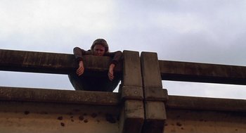 Movie still from “Monster” (2003), directed by Patty Jenkins – A woman sitting on top of a wooden structure; Wide shot, Low angle