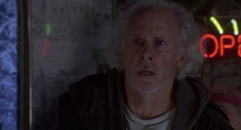 Movie still from “Monster” (2003), directed by Patty Jenkins – An older man with white hair looking at the camera; Close Up shot, Over the shoulder angle