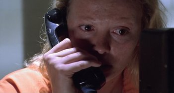 Movie still from “Monster” (2003), directed by Patty Jenkins – A woman holding a phone up to her face; Close Up shot, Low angle