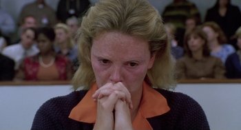 Movie still from “Monster” (2003), directed by Patty Jenkins – A person with her hands clasped together; Close Up shot, High angle