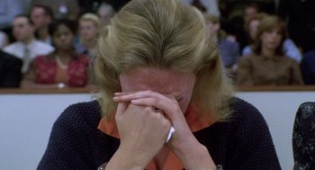 Movie still from “Monster” (2003), directed by Patty Jenkins – A woman with her hands covering her face; Close Up shot, High angle