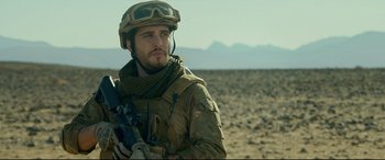 Movie still from “Monster Hunter” (2020), directed by Paul W.S. Anderson – A man in a military uniform holding a rifle; Close Up shot, Over the shoulder angle