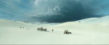 Movie still from “Monster Hunter” (2020), directed by Paul W.S. Anderson – A group of people standing on top of a snow covered field; Extreme Wide shot, High angle