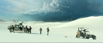 Movie still from “Monster Hunter” (2020), directed by Paul W.S. Anderson – A group of soldiers in the desert under a cloudy sky; Extreme Wide shot, Low angle