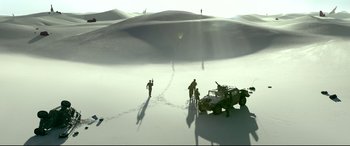 Movie still from “Monster Hunter” (2020), directed by Paul W.S. Anderson – A group of men standing around a vehicle in the desert; Extreme Wide shot, High angle