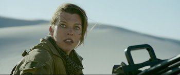 Movie still from “Monster Hunter” (2020), directed by Paul W.S. Anderson – A person with a camera; Close Up shot, Low angle