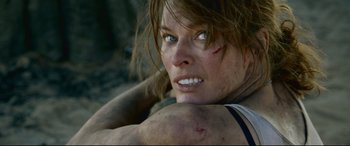 Movie still from “Monster Hunter” (2020), directed by Paul W.S. Anderson – A person with a bruise on her face; Close Up shot, Low angle
