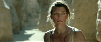 Movie still from “Monster Hunter” (2020), directed by Paul W.S. Anderson – A person wearing a tank top; Close Up shot, Low angle