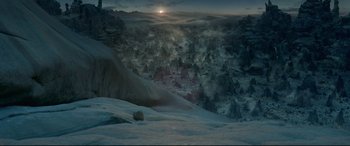 Movie still from “Monster Hunter” (2020), directed by Paul W.S. Anderson – The sun is setting over a snowy mountain; Extreme Wide shot, High angle