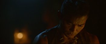 Movie still from “Monster Hunter” (2020), directed by Paul W.S. Anderson – A man's face in the dark; Close Up shot, Over the shoulder angle