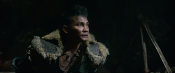 Movie still from “Monster Hunter” (2020), directed by Paul W.S. Anderson – A man wearing a leather jacket and a fur coat; Close Up shot, Over the shoulder angle