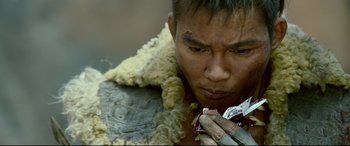 Movie still from “Monster Hunter” (2020), directed by Paul W.S. Anderson – A person holding food in his hands; Extreme Close Up shot, High angle