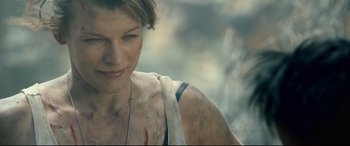 Movie still from “Monster Hunter” (2020), directed by Paul W.S. Anderson – A person with a scar on their face; Close Up shot, Over the shoulder angle