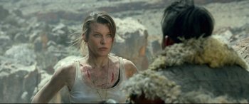 Movie still from “Monster Hunter” (2020), directed by Paul W.S. Anderson – Milla jovovich in a scene from resident evil : the final chapter; Close Up shot, Over the shoulder angle
