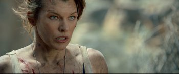 Movie still from “Monster Hunter” (2020), directed by Paul W.S. Anderson – A person with a necklace; Close Up shot, Over the shoulder angle