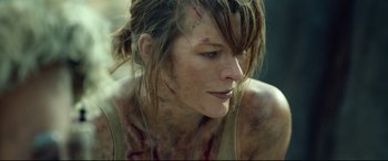 Movie still from “Monster Hunter” (2020), directed by Paul W.S. Anderson – A person with blood all over her face; Close Up shot, Over the shoulder angle